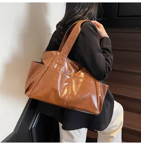 Macro detail of the vintage brown tote bag with multi-pocket design and leather texture