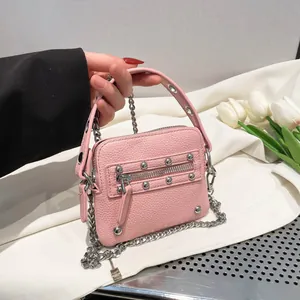 Pink lychee grain leather mini rivet motorcycle bag with silver chain strap for women