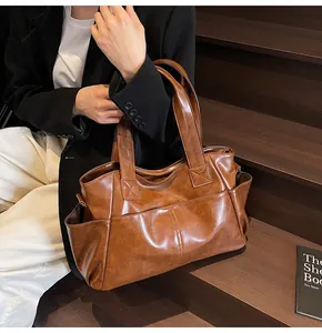Close-up of vintage brown large capacity tote bag with functional front and side pockets