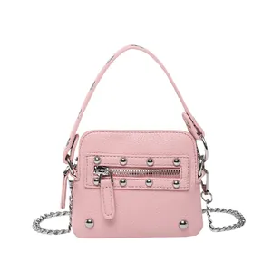 Pink lychee grain leather mini crossbody bag with silver studs and chain strap