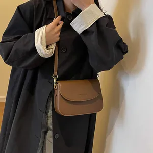 Classic brown leather small square crossbody bag with adjustable strap and flap design