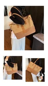 Détail du sac cabas en denim bicolore avec anses en cuir et texture tissée