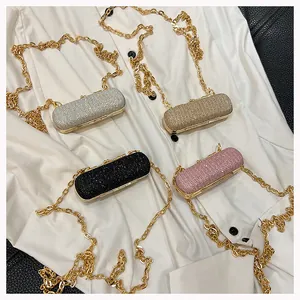 Close-up of mini luxury evening bags in silver, gold, black, and pink with gold chains