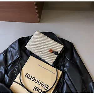 Straw woven mini square crossbody bag on leather jacket with aesthetic book decor