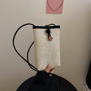 Mini straw woven phone crossbody bag with petal button and black shoulder strap