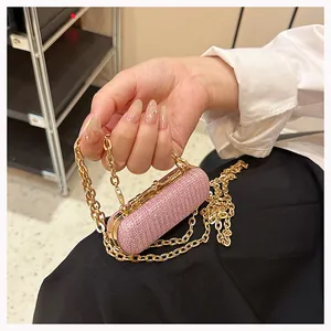 Close-up of pink glitter mini evening bag with gold metal trim and chunky chain