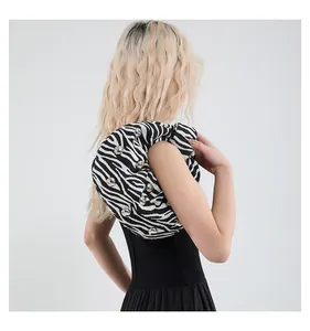 Detail of zebra print shoulder bag with silver studs on a black and white fabric