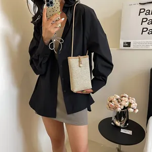 Straw woven mini crossbody bag for women featuring cream contrast colors and slim strap