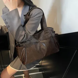 Large dark brown PU leather tote bag with double front pockets for commuting and daily use