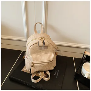Elegant beige floral embossed mini backpack with dual zippers and slim straps