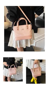 Detail showing pink canvas tote bag with leather bottom and adjustable shoulder strap