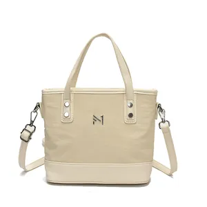 Chic beige canvas tote bag with leather trim and adjustable strap for women