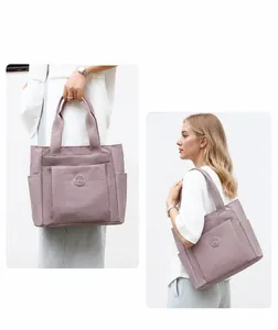 Detail view of nylon tote bags showing side pockets and versatile shoulder straps