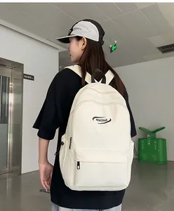 Minimalist beige high-capacity backpack with MRMIBAG logo shown on a model