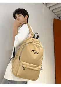 Detail of minimalist khaki nylon backpack featuring a zip pocket and MRMIBAG logo