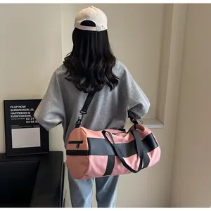 Borsa da palestra rosa cilindrica con finiture in pelle nera e tracolla regolabile