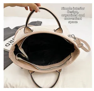 Top view of cream bucket bag showing large interior space with black lining and pockets