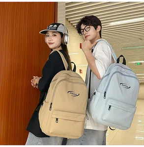 Detail of high-capacity nylon backpacks in khaki and light blue for students
