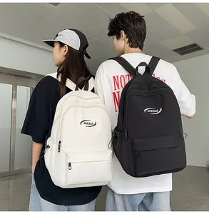 Front view of black and white minimalist backpacks with large pockets and zipper closure
