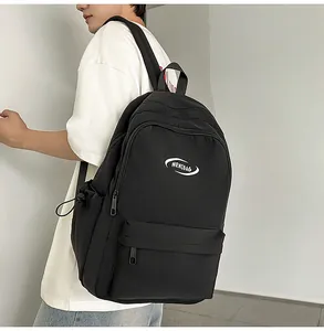 Side view of black MRMIBAG minimalist canvas backpack with large capacity and logo detail