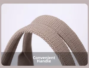 Detail of reinforced woven handles on a khaki nylon shoulder bag with a focus on texture