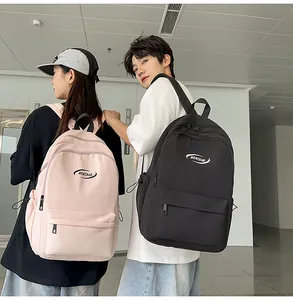 Detail of pink and black casual school backpacks featuring MRMIBAG logo and front zip pockets