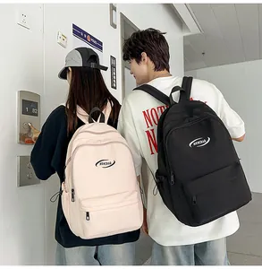 Detail of minimalist school backpacks in pink and black featuring MRNIBAG logo design