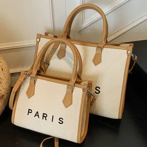 Minimalist canvas tote bags with brown leather trim in large and small sizes