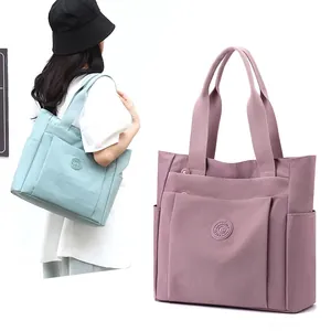 Large nylon tote bag for women featuring multiple pockets and durable shoulder straps
