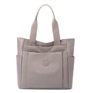 Large capacity taupe nylon tote bag with multiple pockets and top handles for women