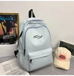 Detail of light blue backpack with large main compartment and front zipper pocket