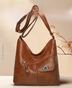 Close-up of vintage brown leather bag detail with front zipper and metal lock pocket