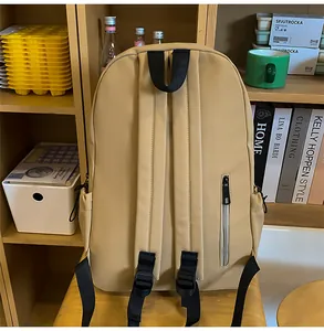 Detail of khaki nylon backpack back with adjustable straps and vertical anti-theft pocket