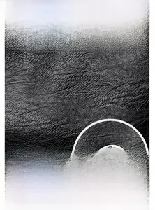Detail of black litchi grain leather texture and metal twist lock on shoulder bag