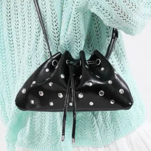 Chic black drawstring bucket bag with silver studs and pleats for stylish shoulder carry