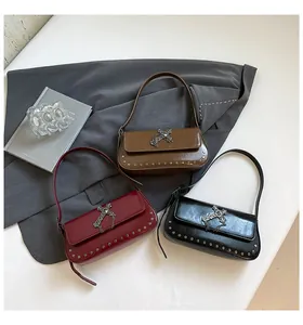 Detailed view of vintage crossbody bags in brown, burgundy, and black with rivet details