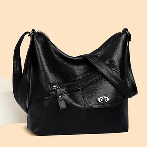 Black vintage leather hobo shoulder bag with multiple zippers and silver buckle
