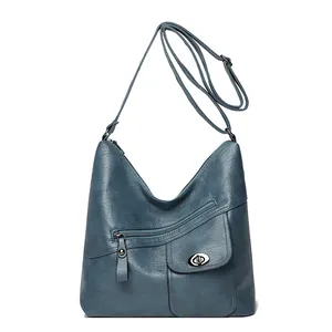 Vintage navy blue faux leather crossbody bag with multiple pockets and adjustable strap