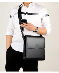 Close-up of litchi grain leather texture and embossed logo on men's black business bag