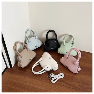 Close-up of pebble leather handbags in multiple colors with detachable shoulder straps