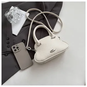 Close-up of off-white lychee grain leather handbag with silver metallic hardware detail