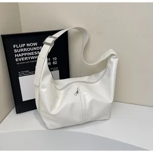 Detail of white PU leather hobo bag with wide adjustable strap and silver metal zipper