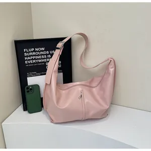 Detail view of pink PU leather shoulder bag featuring a wide strap and vertical zipper