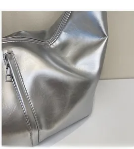 Close-up of metallic silver tote bag detailing textured PU leather and durable zipper