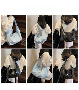 Fashionable high-gloss underarm tote bag showing draping effect and model styling