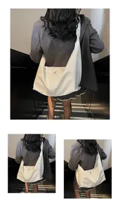 Detail of white large-capacity tote bag in glossy PU leather with wide shoulder strap