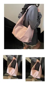 Detail view of pink glossy faux leather tote bag with mirror finish and large capacity