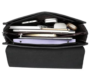 Internal view of business shoulder bag showing multi-compartment storage for laptop and gadgets