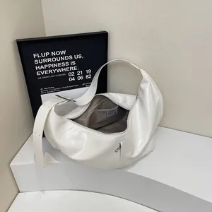 White large capacity hobo bag in glossy leather with wide shoulder strap and silver buckle