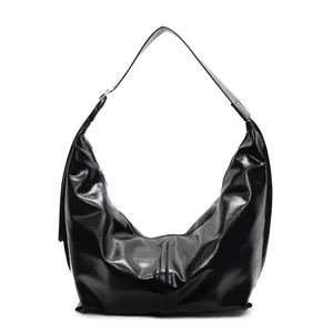 Chic black glossy leather hobo bag with crescent moon shape and wide shoulder strap